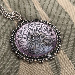 Purple and silver circular medallion necklace.